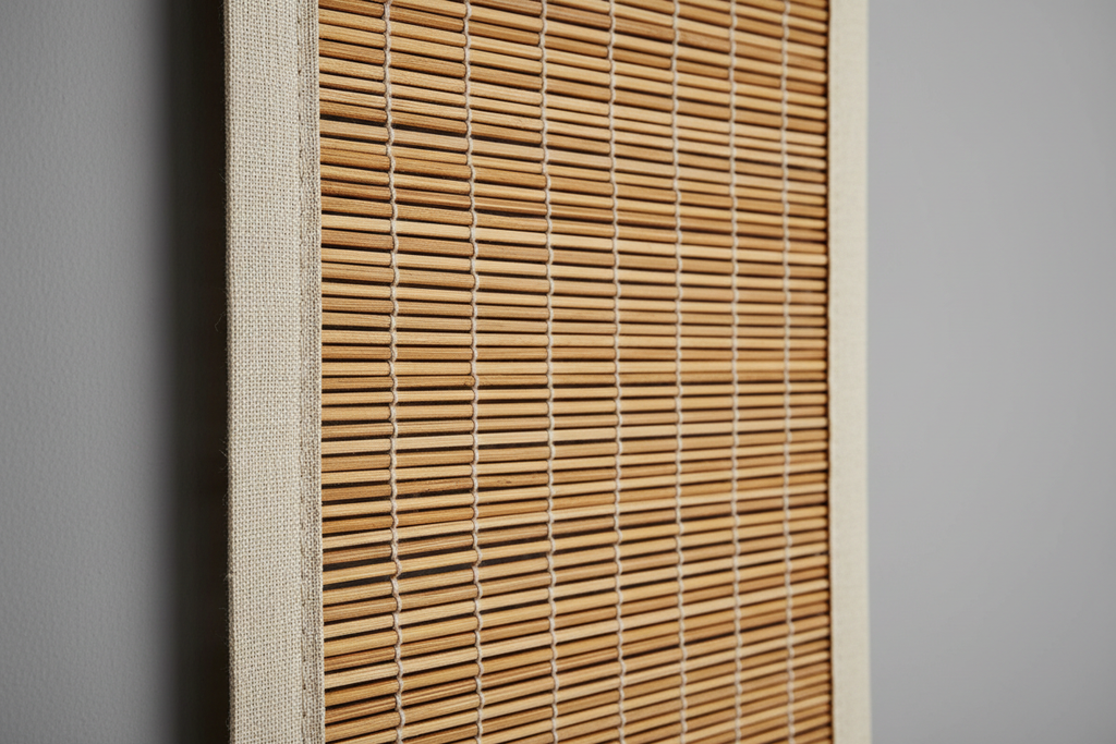 Close-up of hand-woven natural bamboo reed texture with subtle color variation and decorative edge banding