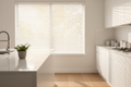 Classic 2 inch faux wood blinds in soft white installed in a bright modern kitchen