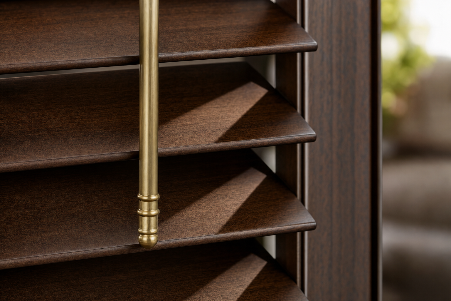Close-up of hand-stained walnut louvers with a brass tilt-rod showing natural wood grain